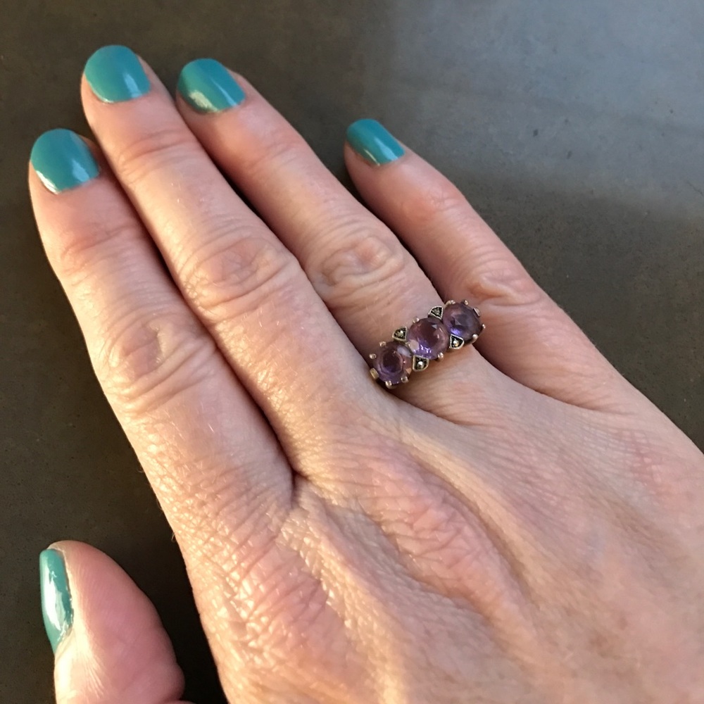 Silver ring with amethyst colored stones. Size 7.