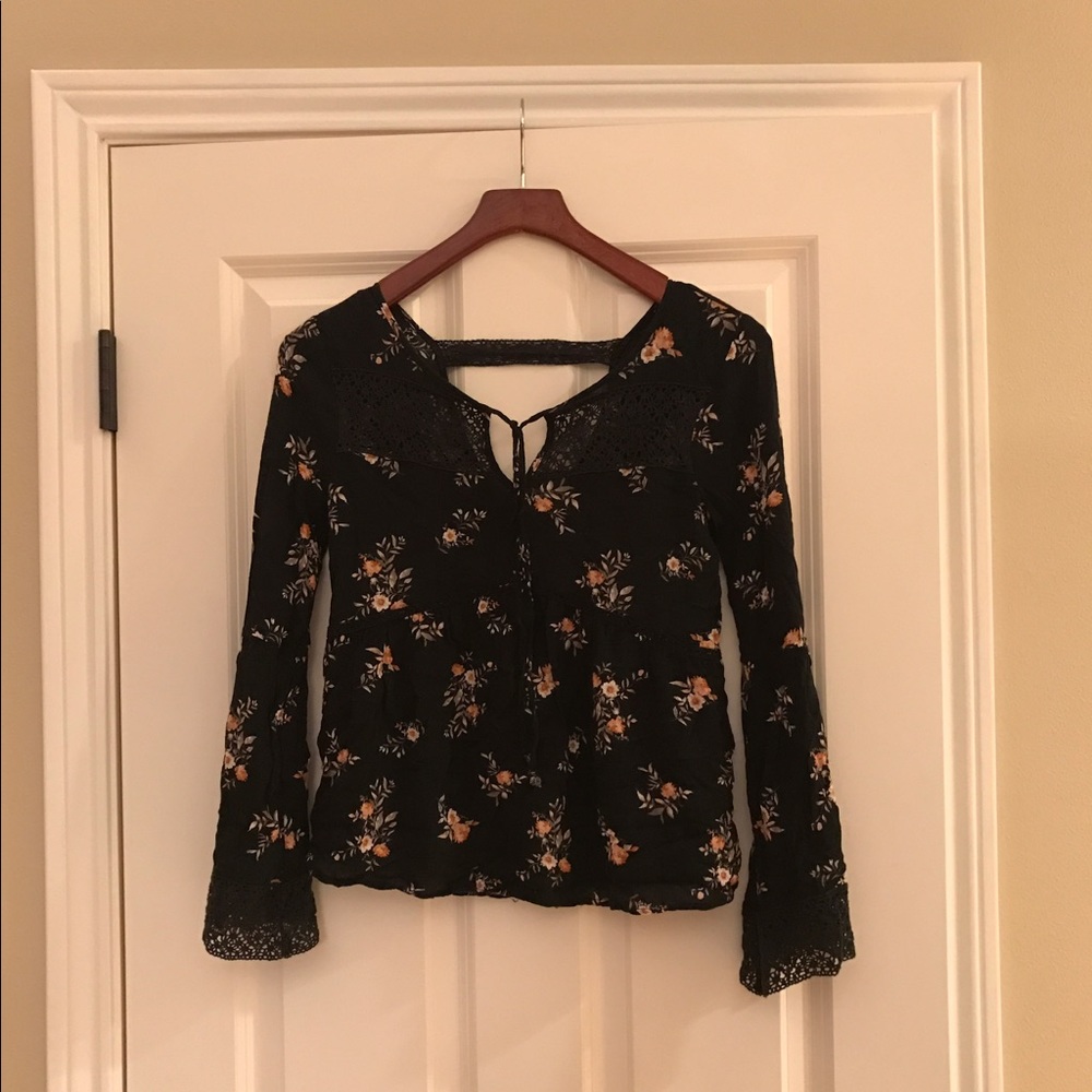 Black shirt with floral print.