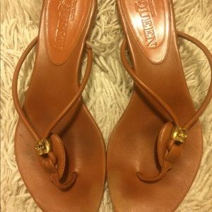 Tan leather flip flops with gold skull bead