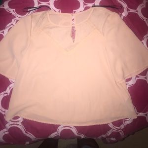 Pink shirt. There are some small tags on the shirt