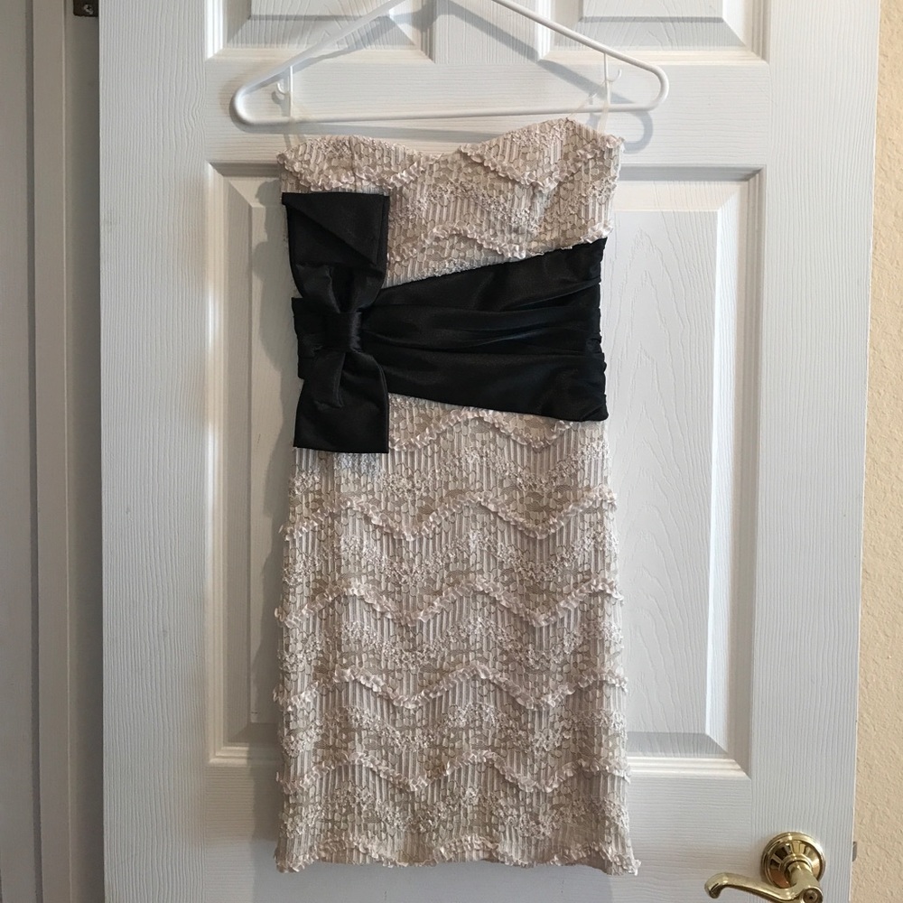 sleeveless cream dress with black bow