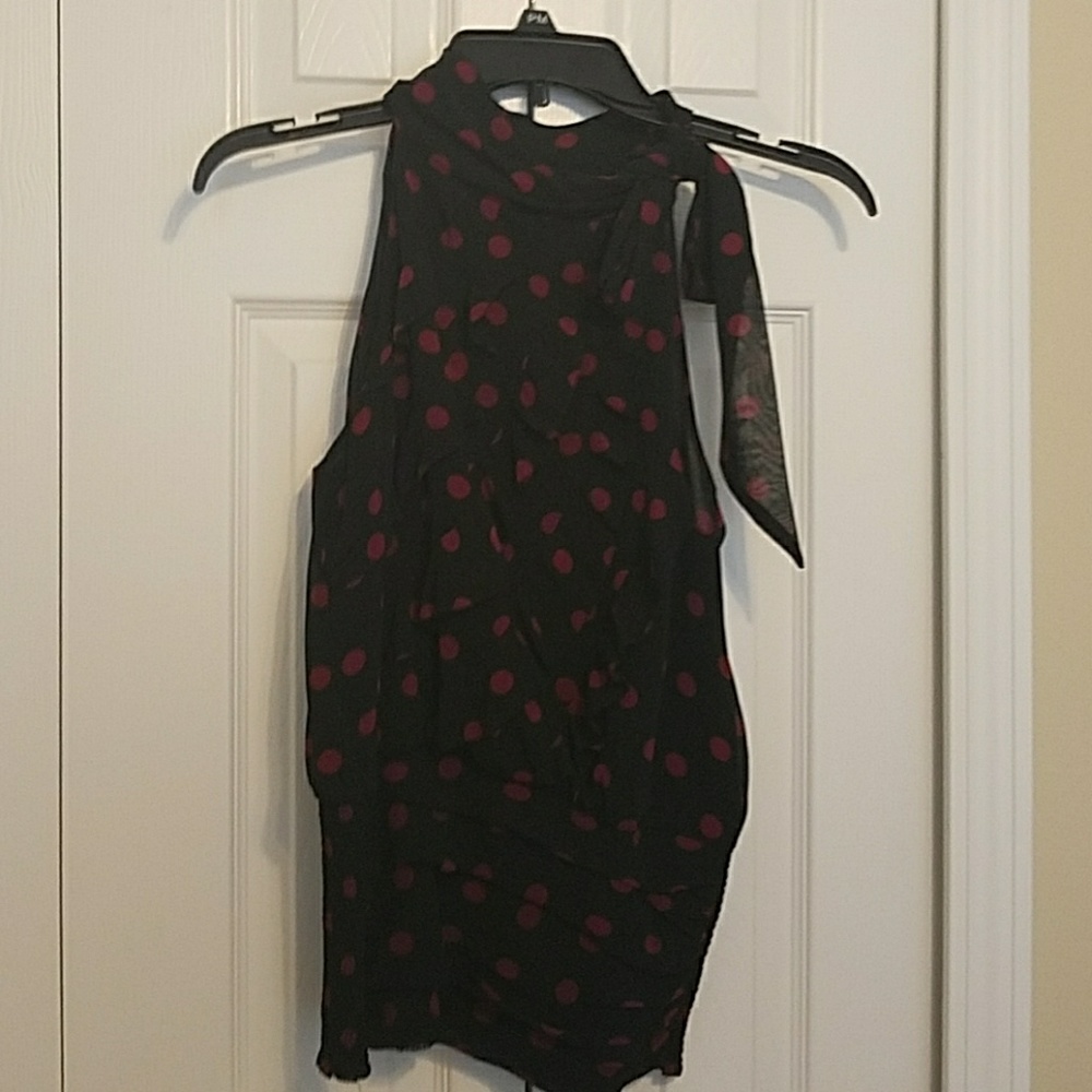 Polka dot sleeveless blouse with offset bow.