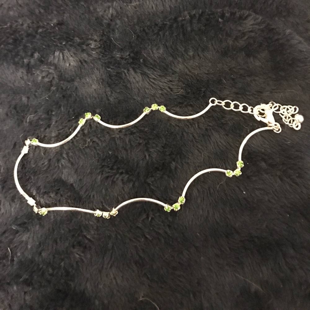 Silver bracelet with green gems