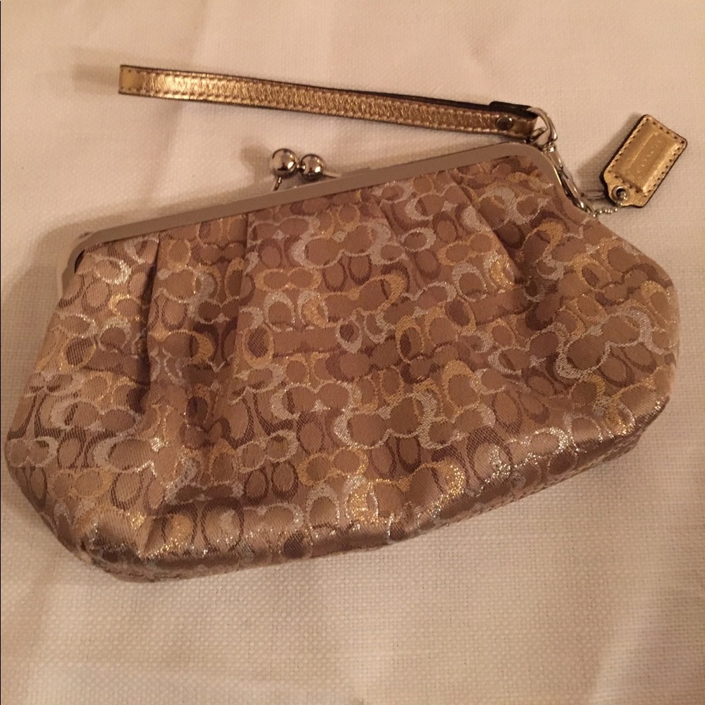 Coach clutch with metallic logo pattern