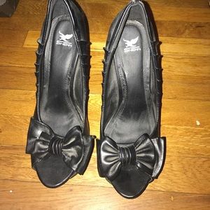 Black platform high heels with bow accent