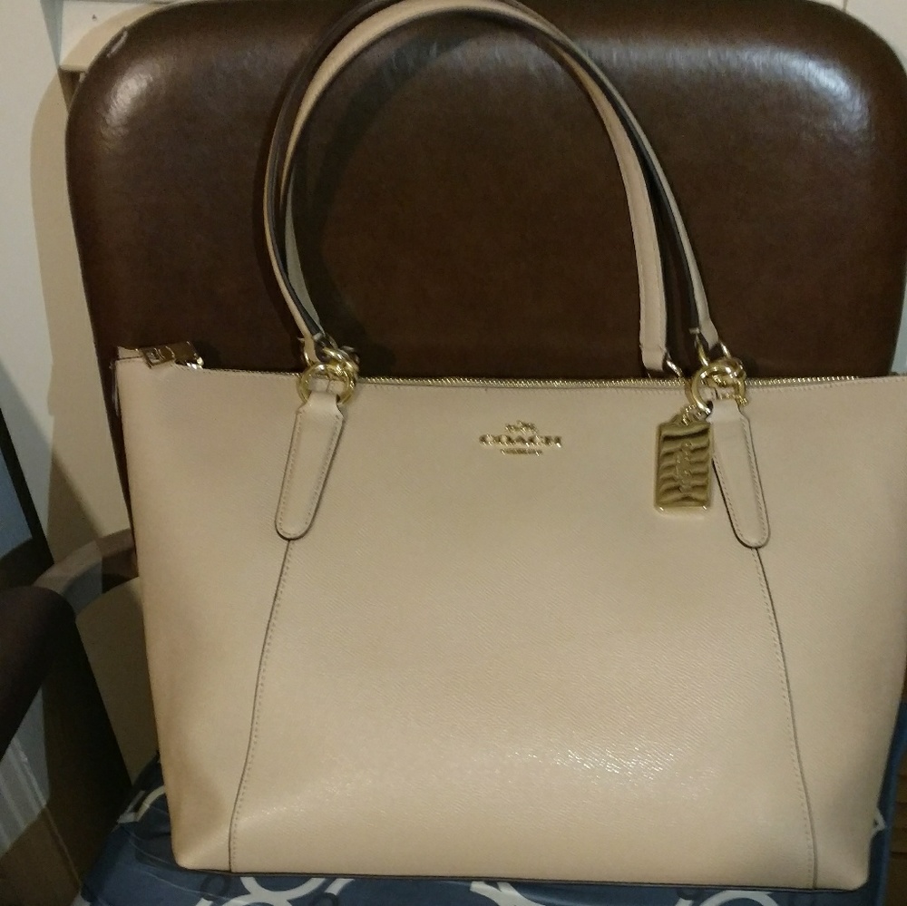 Cute pinkish brown coach purse.