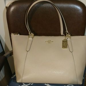 Cute pinkish brown coach purse.