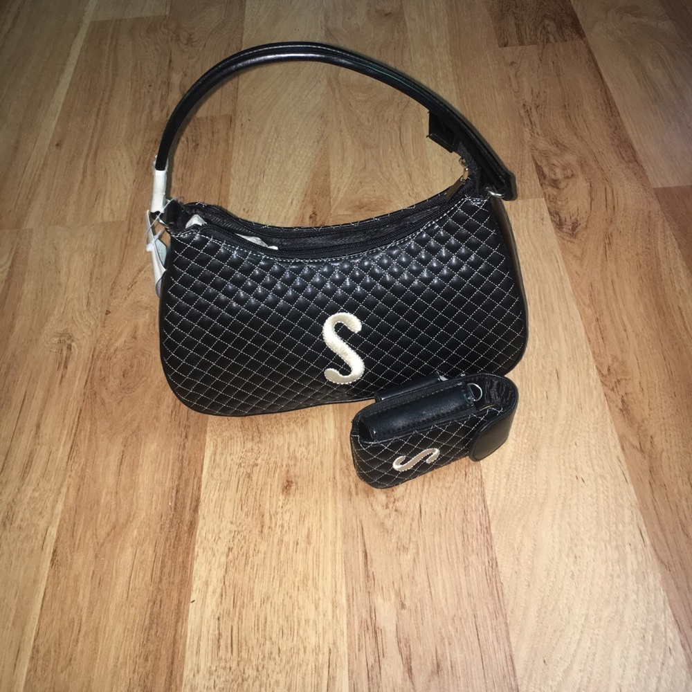 Never been carried purse with a cell phone holder!