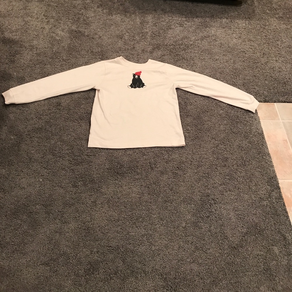 White t shirt with a black bear with a red hat