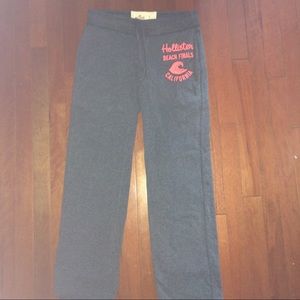 grey hollister comfy pants w/ pink writing