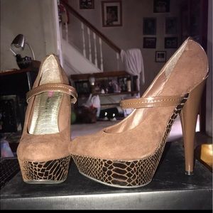 Brown pumps with design on bottom