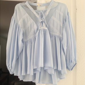 Blue, flowing, lace up top by Blu Pepper.