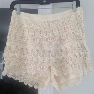 Crotched, lace, white high waisted shorts.