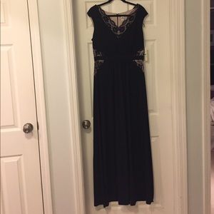 Full length black dress with lace detailing.