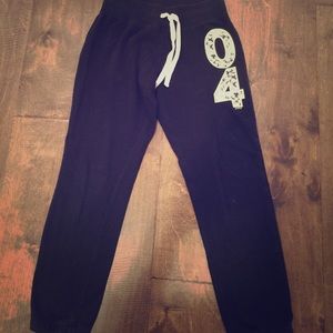 Black joggers that has a flower print on the side