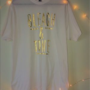 white t shirt with gold foiled letters