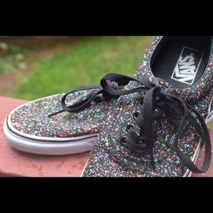 Black lace up Vans with paint splatter design.
