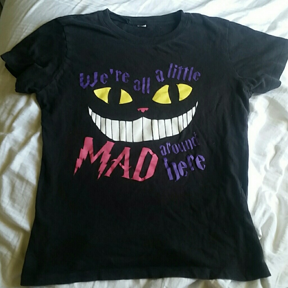 black t-shirt and referring to the Cheshire Cat