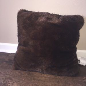 A furry throw pillow for the couch and bed!!