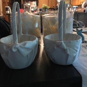 Two flower girl baskets with petals