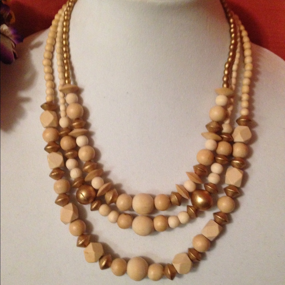 Wood 3 strand beaded necklace with gold accents.