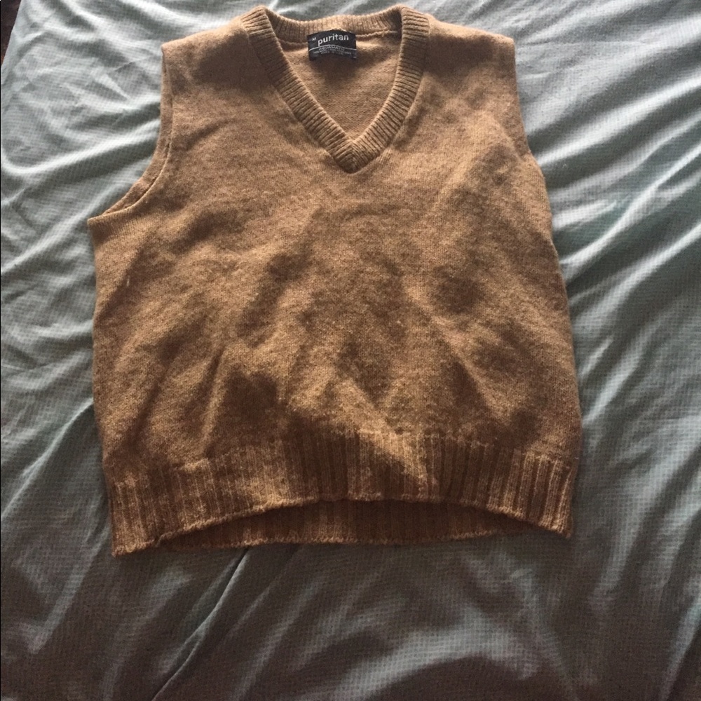This a a tan sleeveless sweater ready
