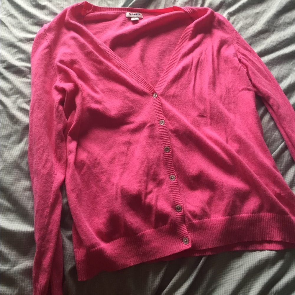 A pink button down v neck sweater