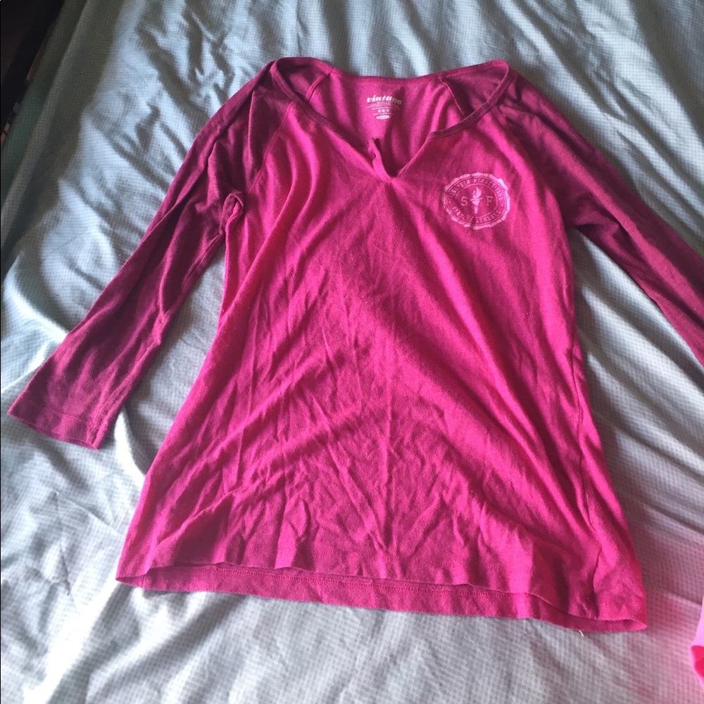 This a pink baseball tee