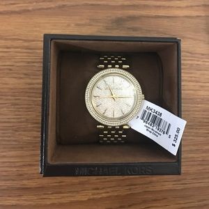 An authentic gold Michael Kors MK3438 watch.