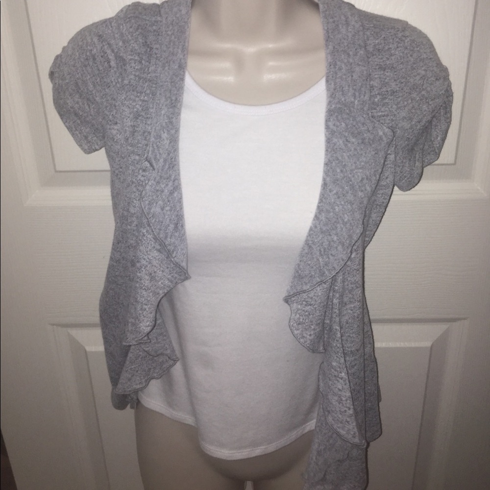 a white top and grey cardigan
