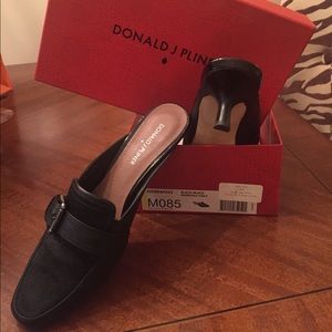 Black leather and calf hair mules .