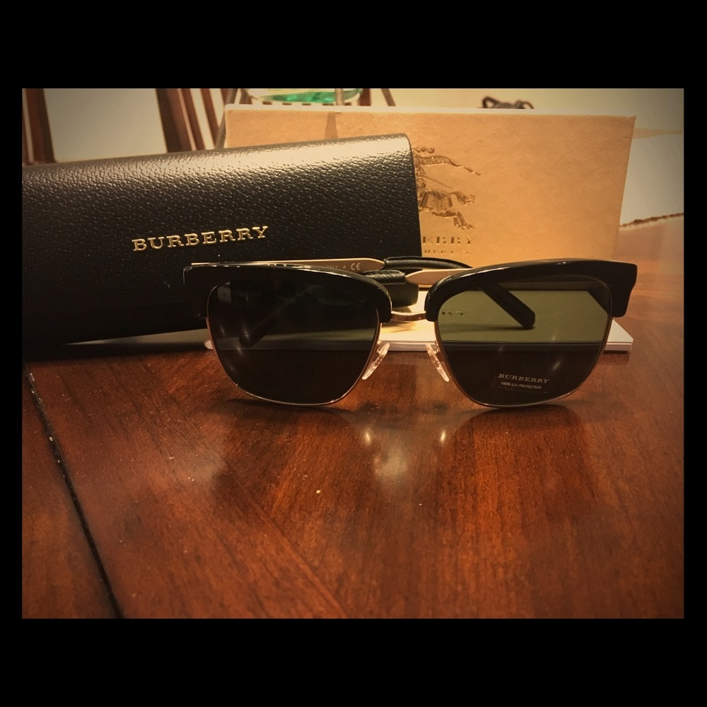 Men's black and gold Burberry sunglasses.