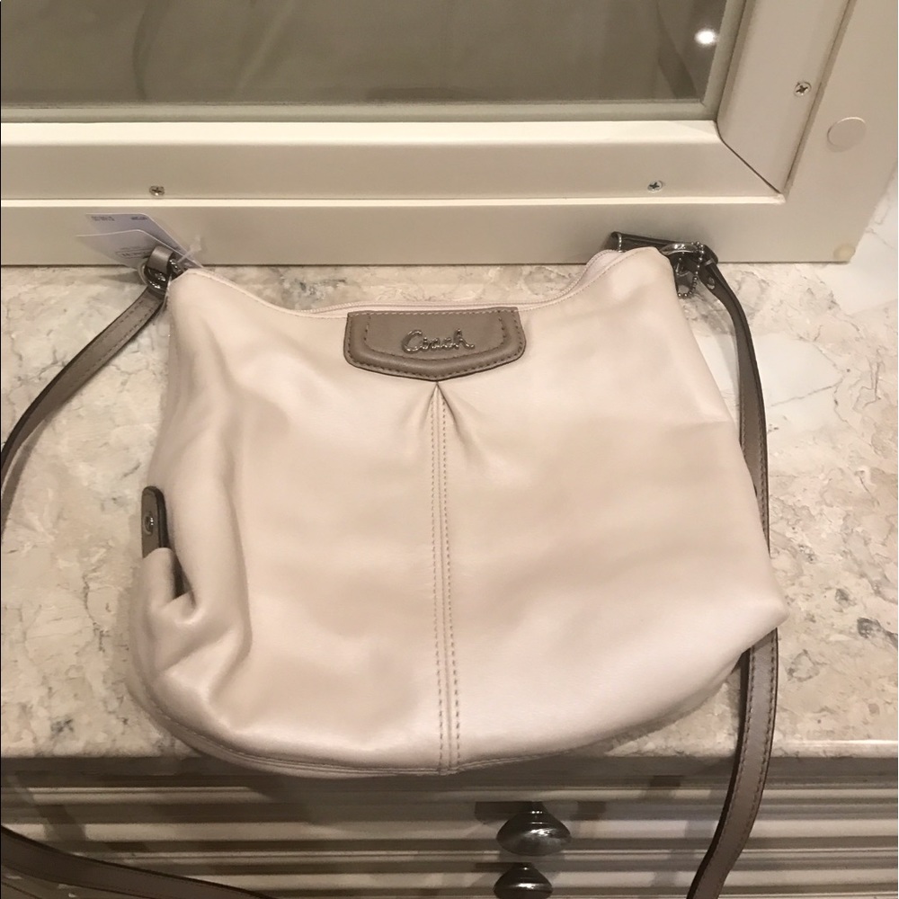 NWT cross body soft leather coach purse.