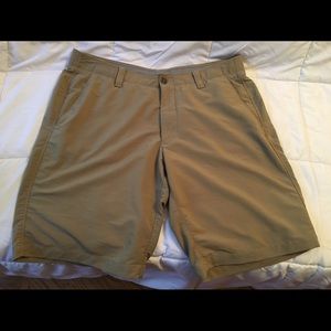 Khaki Under Armour golf shorts.