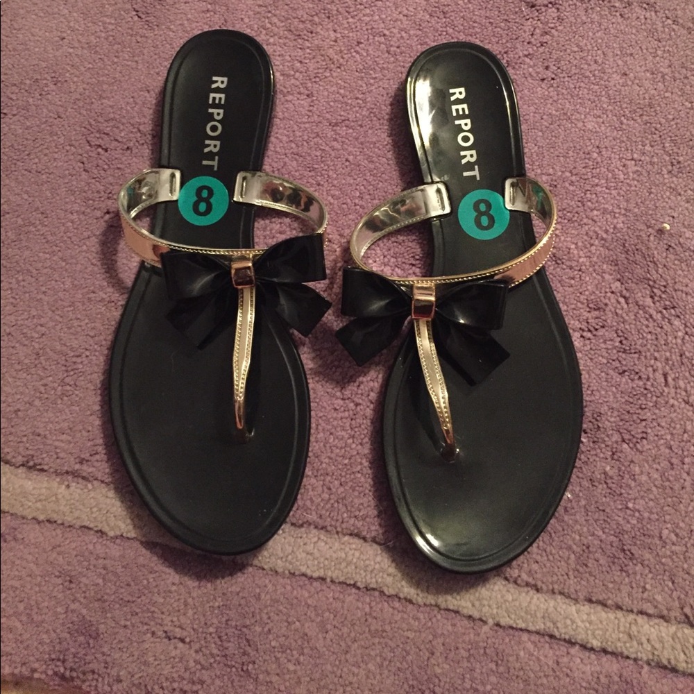 Black and gold bow flip flops