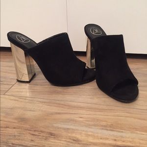 Black mules with gold mirrored heel