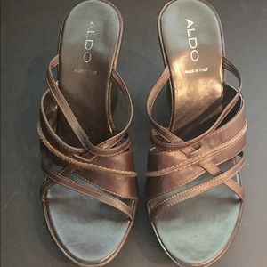 Dark brown backless wedges.