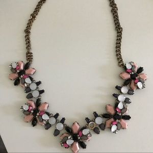 Statement necklace with pink, white, black gems.