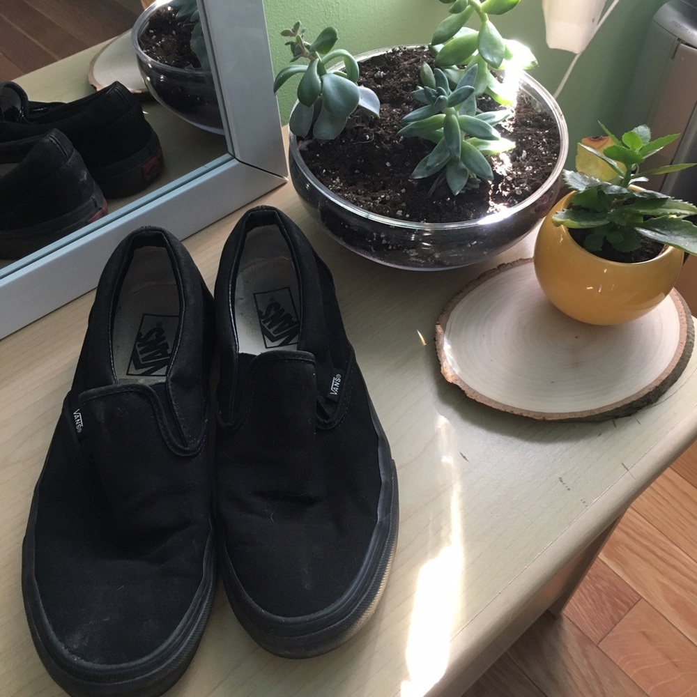 "Vans" slip on all black shoes.