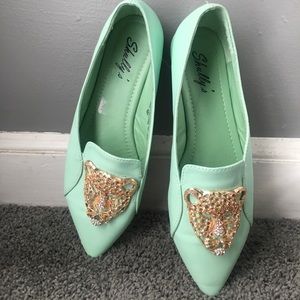Mint colored flats with leopard embellishment.