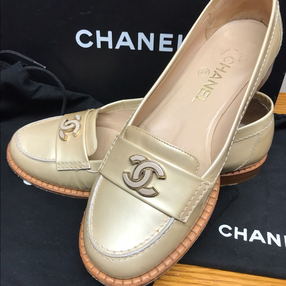 Chanel beige patent moccasin loafers.