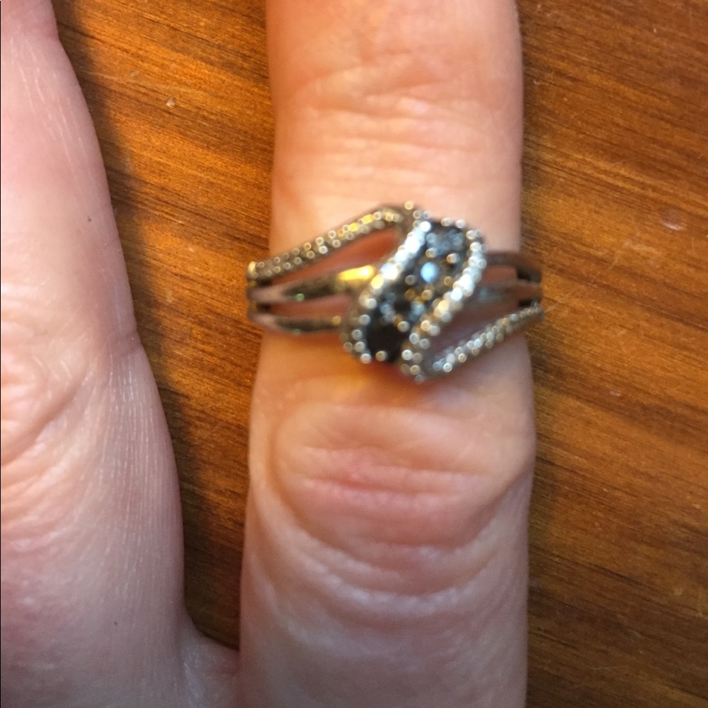 Silver tone with possibly black crystals ring
