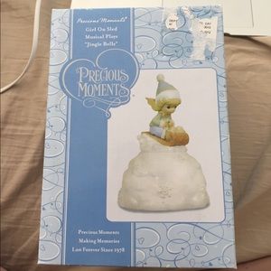 Precious moments girl on sled