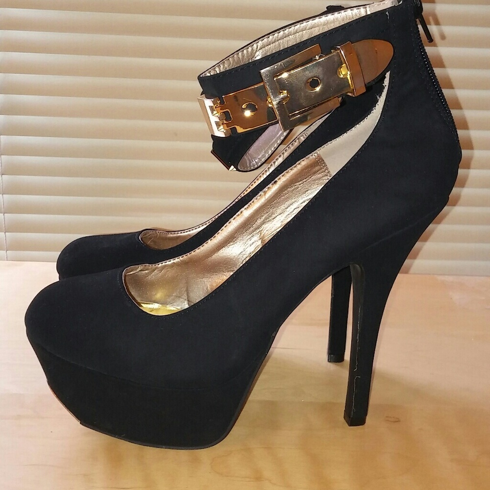 Black pumps with ankle strap and gold buckle