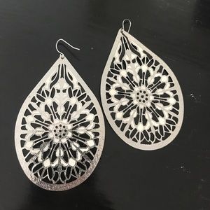 Large, teardrop, black-white-silver earrings.