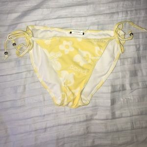 Yellow swimming suit with white beachy designs