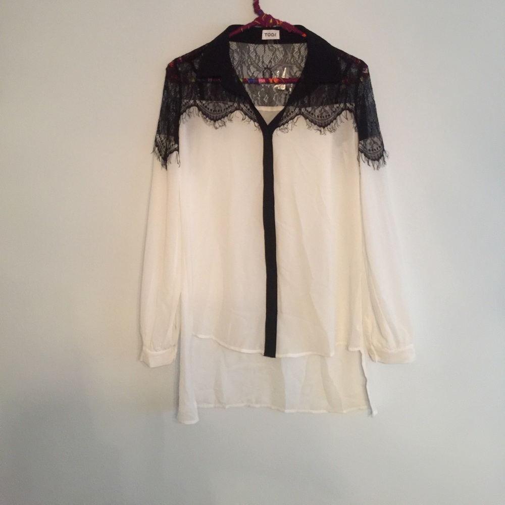 White blouse w/ black lace detailing and buttoning