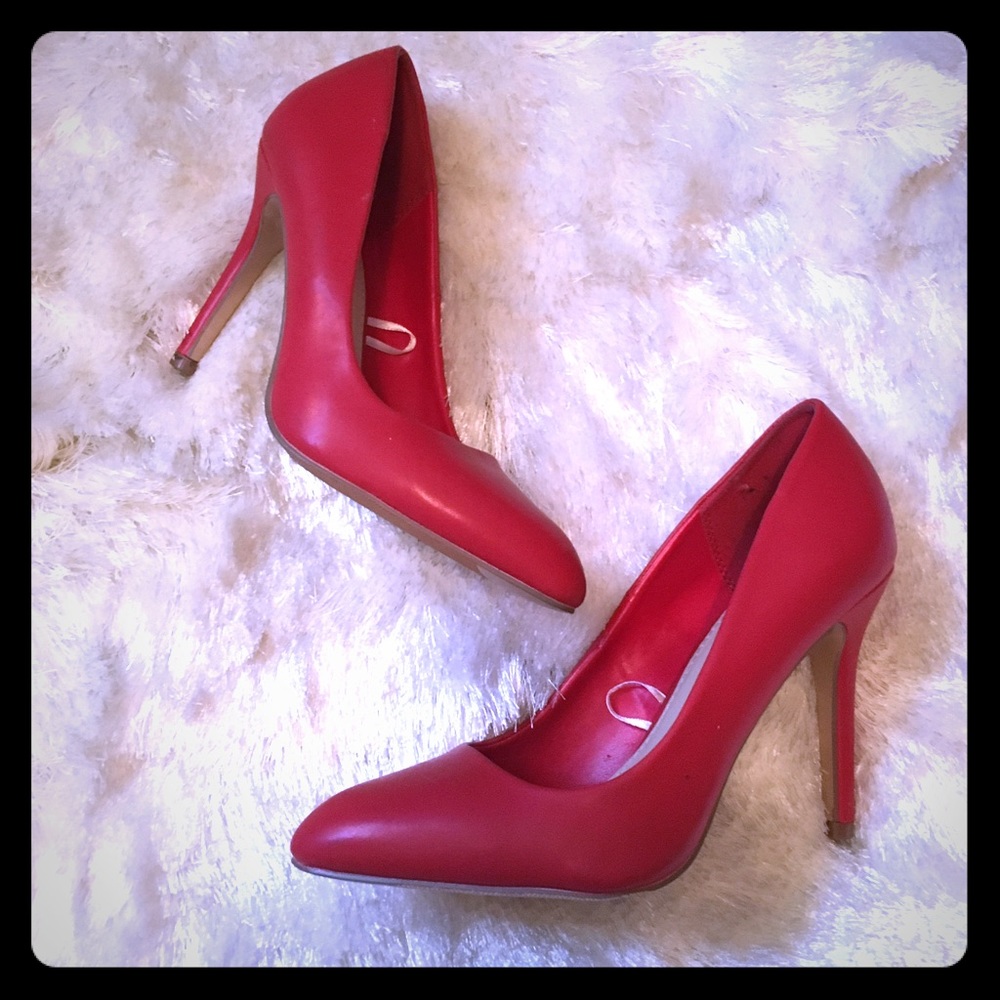 Red stiletto pointed toe pumps.