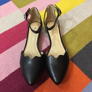 Pointed toe, scalloped ankle strap, flats.