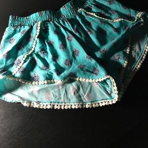 Teal blue shorts w/ small floral patterns